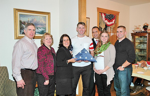The Hedberg Family along with Mayor Diaz and Chief Ruiz proud- ly pose with Joshua. Marine Sergeant Joshua Hedberg will serve in Seoul, South Korea for two years. As a Communications Marine, he will be one of the men directly overseeing the security of the mili- tary networks running throughout the Pacific theater.
