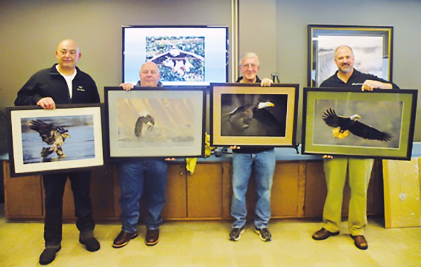 Left to right, Ami Dyan of Perth Amboy, N.J. (fourth place winner), Herbert Burket of Paradise, Pa. (third place winner),  Paul McFadden of Lebanon, Pa. (second place winner) and displaying the 2014 winning photo ”Bald Eagle Soaring”  by  Mitch Adolph of Lutherville, Md. is  Conowingo Shoreline Specialist Fred Smith.