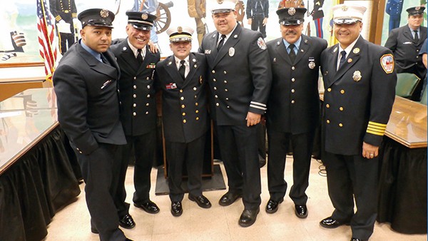 Abraham Pitre (third from left) is congratulated after he is sworn in as Fire Chief at Perth Amboy City Hall