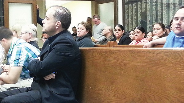Resident and Businessman David Caba listens to the Council proceedings along with several employees of Nelvi Bus Company *Photo by Carolyn Maxwell