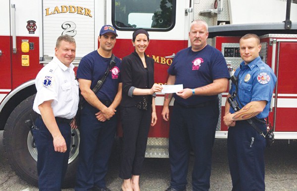 PERTH AMBOY - Perth Amboy Firefighters and Fire Officers I.A.F.F. Locals 286 & 4070 presenting a donation to  a representative from the Susan G. Komen Foundation from T-Shirts sales for breast cancer research. Photos submitted