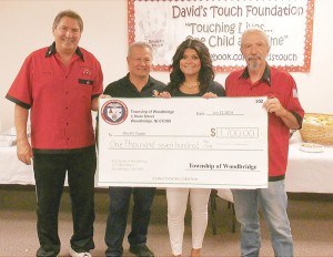 A check For $1,700 from Woodbridge Twp. - (L to R) Tournament Organizer Harry Witt, David’s Grandfather Lauro Perez, David’s mom and Founder of DTF Jenny Rosado and Woodbridge Seniors Billiard Club President Tom Colandro.