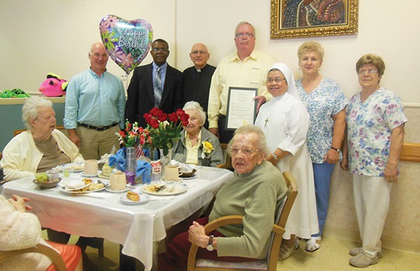Anna Krentar (center) and staff at St Joseph's Assisted Living in Woodbridge, with other residents