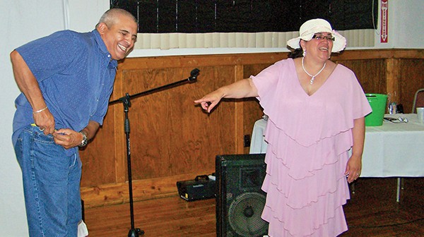 Pastor Berny Falcon-Lopez and Husband Pastor Raul share a light-hearted moment at the Victorian Tea held at the Knights of Columbus on July 20, 2014.