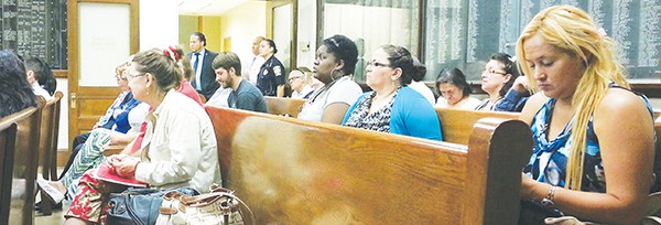 Residents and city employees listen while comments are made at the Meeting.