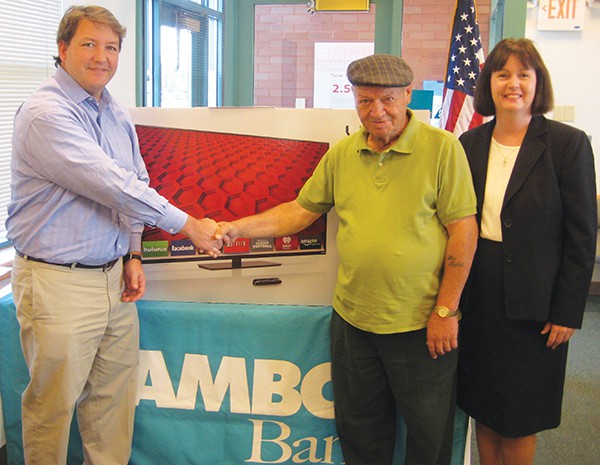 Greg Scharpf , Amboy Bank's SVP & Chief Retail Officer, and Alice Mesa, Ernston Branch Manager, congratulate sweepstakes winner Mauro Rutigliano. 