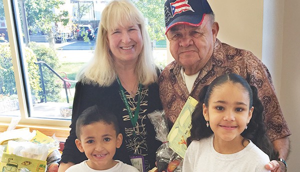 Pictured in photo are : Mrs. Rose Pennyfeather, Mr. Ramon Arce-Rodriguez (recipient), with students, Julian and Hannah Ceballos.