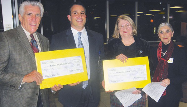 On December 4, 2014 at the RBMC Annual Tree Lighting Ceremony the Perth Amboy Auxiliary presented a check for $20,000 and the Ernest R. Hansen Auxiliary presented a check for $5,000 to RBMC fulfilling their annual pledges. (L to R) Russ Azzarello, William DiStanislao, Marcella Massopust and Carmela Guarnera.