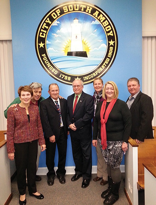 SOUTH AMBOY - (L to R) Councilwoman Zusette Datom Councilman Mickey Gross, Council President Joe Connors, Mayor Fred Henry, Councilwoman Christine Noble, B.A. Camille Tooker and Councilman Donald Applegate pose under the City Seal in the Council Chambers after the 12/17/14 meeting. *Photo by Carolyn Maxwell