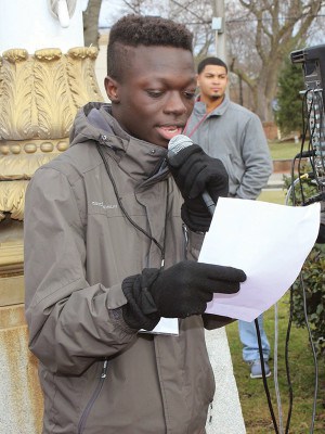 PAHS Senior Class President Abdul Diof reads a speech at City Hall Circle about how youth play a part to bring together unity in the community.