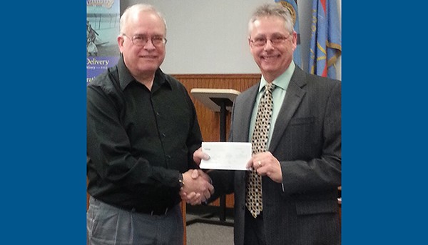 SOUTH AMBOY - Mayor Fred Henry receives a donation for the St. Patrick’s Day Parade from Gerald Ricciardi, Area Manager for JCP&L Community and Customer Relations at the 3/4/15 Business Meeting. *Photo by Carolyn Maxwell