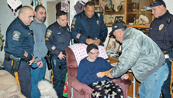PERTH AMBOY - The HyTaverngang presented a check on 2/27/15 to Ms. Donna Pryga, a Perth Amboy cancer survivor, to help with the purchase of a much needed chairlift. The group held a Cigar Night last week to raise the money. The HyTaverngang was formed by Perth Amboy police officer Harry Scheman who got together a group of friends and fellow officers who wanted to help out our community. In the past few years we have held various fund raisers including Pig Roast, yard sales and cigar nights. We have contributed to JRC for cancer screenings, the Eddie Febles Scholarship Fund, Project Lifesaver and National Night Out among others. Our next event is a fundraiser for Project Lifesaver, to buy 2 new bracelets for the safety of Alzheimer’s and dementia patients. It will be on St. Patrick’s Day at the Hy Tavern. We will be serving up Mom’s famous corned beef and cabbage for a five dollar donation.