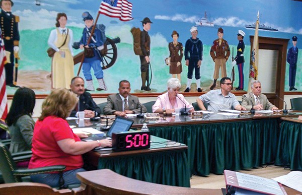 Newly Sworn in Councilman Fernando Gonzalez takes his seat once more on the Council at the 5/27/15 Caucus and Council Meeting. *Photo by Katherine Massopust