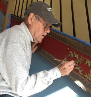 Tom Ward paints the foyer in City Hall *Photo by Noelia Colon