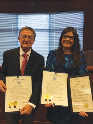 Angelo Befumo, 2015 Columbus Day Grand Marshall, and Brianna Oddo, Ms. Italian-American, display resolutions sponsored by the 19th District legislators in their honor.