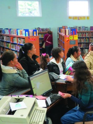 Adults and Children take out books 