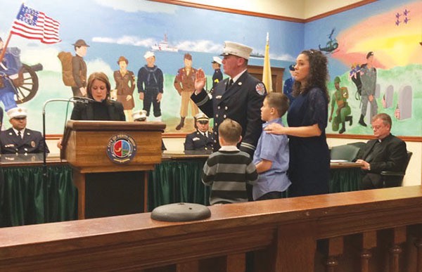 Robert Bunten is promoted to Captain in the Perth Amboy Fire Dept. in the City Hall Council Chambers on 3/3/16. Wife, Nicole and sons, Robert Jr. and Ryan hold the Bible. *Photo Courtesy of the Bunten Family