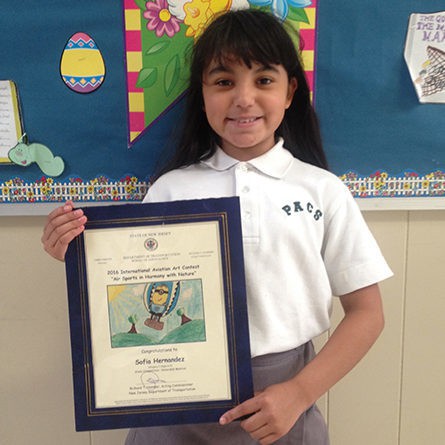 Press Release PERTH AMBOY - Sofia Hernandez, a 4th grade student at Perth Amboy Catholic School, won Honorable Mention in the 2016 International Aviation Art Contest. Sofia received a certificate and copy of her winning entry from The State of New Jersey Department of Transportation, Bureau of Aeronautics. Her winning entry was sent in by her Art Teacher, Rose Pennyfeather. For further information, please contact Rose Pennyfeather at Perth Amboy Catholic School at (732) 826-1598.