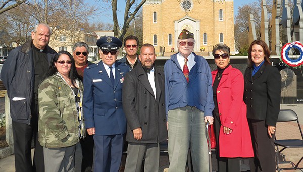 Peter Book (3rd from right) proudly poses with City Officials and other Veterans in front of the Veteran’s Monument *Photo by Bob Ned