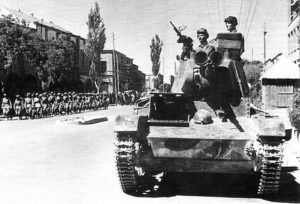 Soviet tankmen of the 6th Armoured Division drive through the streets of Tabriz on their T-26 light tank. Wikipedia. Click to enlarge.