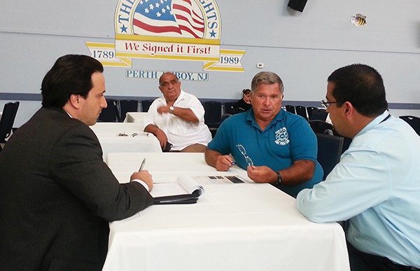 Riverkeeper Bill Schultz speaks with representatives of NJ Transit Raritan River Resilience Program. Cornucopia Cruise Line Owner Mustafa Kilic listens from the back. *Photo by Carolyn Maxwell