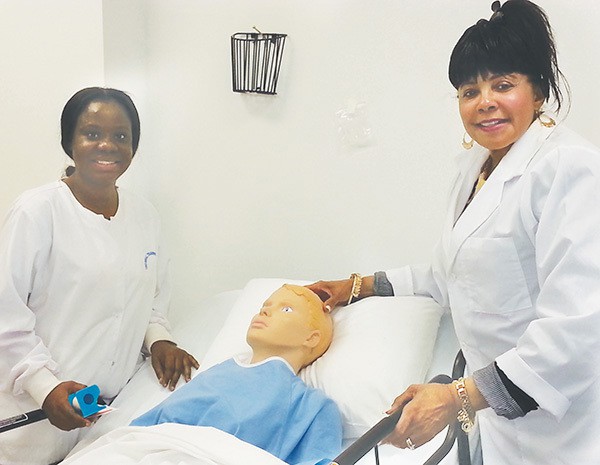 One of the UTI Students (L) and Brenda Dudley (R) show one of the hospital simulation rooms that are used to train students. *Photos by Carolyn Maxwell