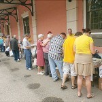 Visitors look over the many vendor tables.