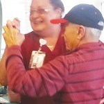 A staff member and a resident enjoy a dance