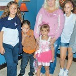 Lexani Rodriguez stands in front of her mom and other family members at the foyer of City Hall.