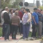A crowd gathers at the scene.