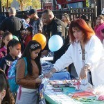 Handing out pamphlets to the children