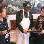 Mayor Diaz presents citation to Hong and Tom Lu.