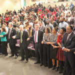 Participants clasp hands during the service at the Cathedral.