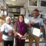 Owner Marcell Ysaac holds a certificate presented to him by Mayor Diaz while his proud mother beams with pride