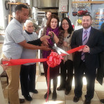 Cutting the Ribbon (L to R) Ana Zevallos, Owner Marcell Ysaac and his Mom, Mayor Diaz, UEZ Coordinator Roxana Troche, Jason Conway VP Area Manager Provident Bank and Sergio Diaz BID Board Member and Manager of 1st Constitution Bank.