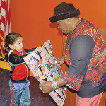 A student presents a painting to Dorothy Daniel