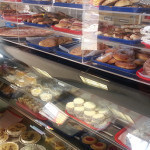 Display case of cakes, pastries and meats for sandwiches