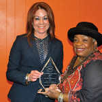 PRAHD Executive Director Yvonne Lopez presents the Arturo Alfonso Schomburg Award to Dorothy Daniel